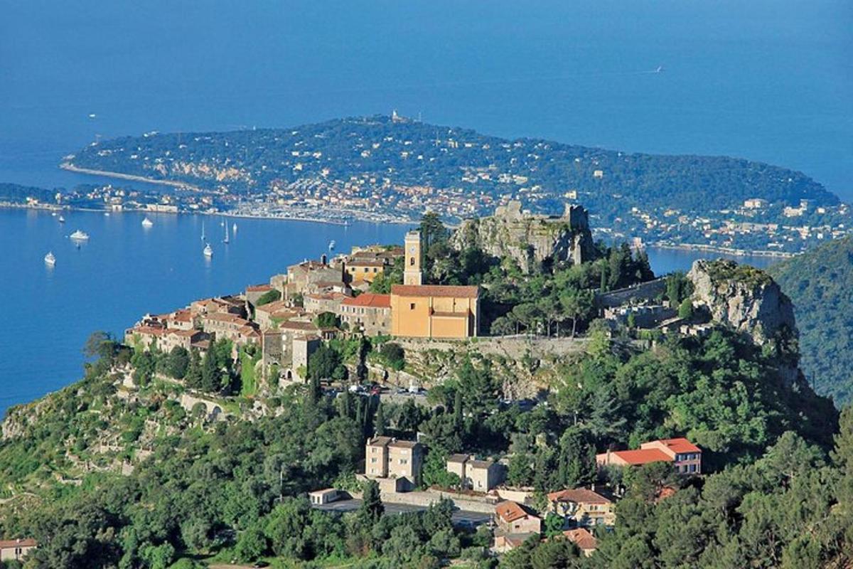 a small town on top of a mountain next to the water