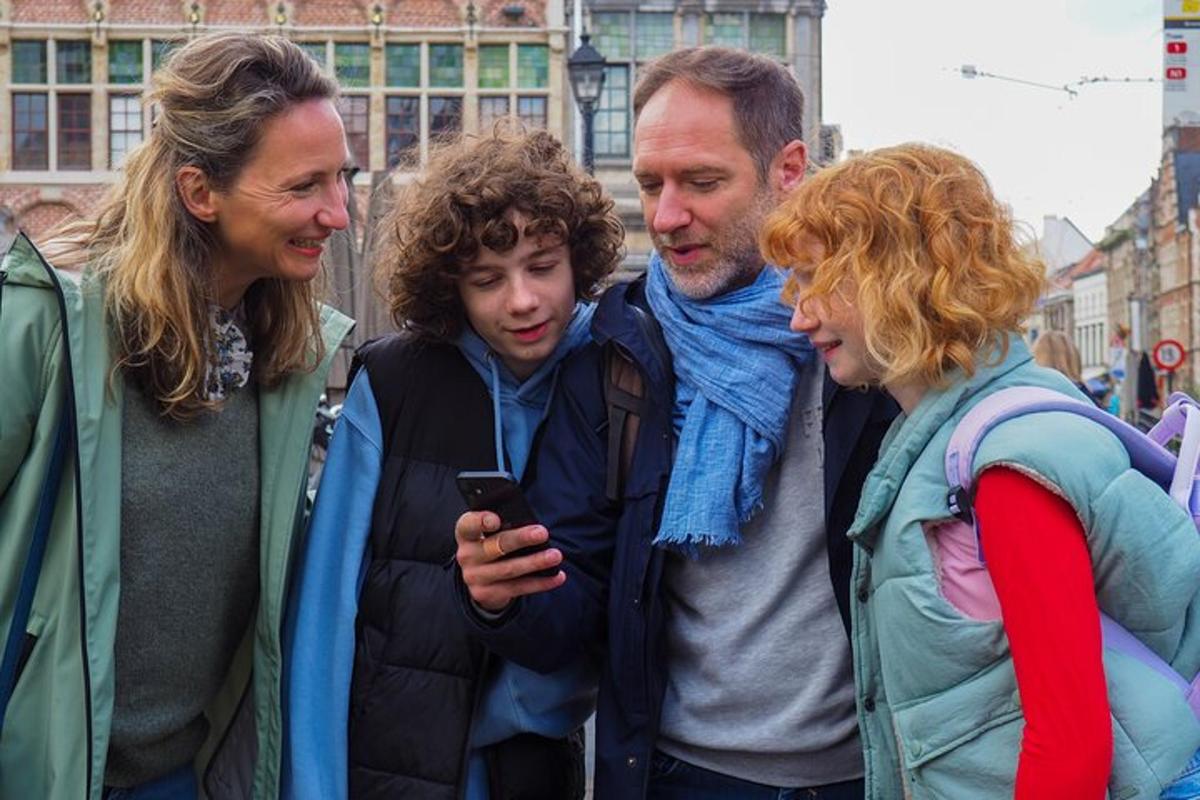 a group of people looking at a cell phone