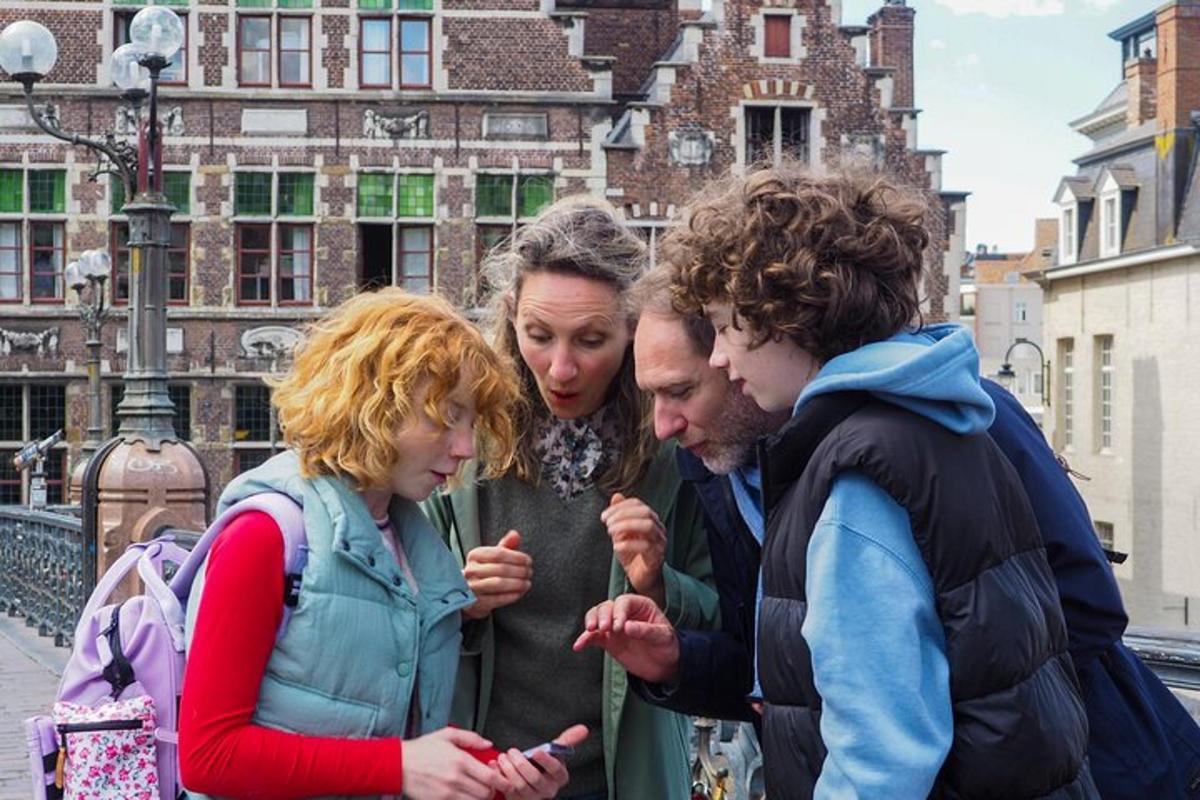 a group of people looking at a cell phone