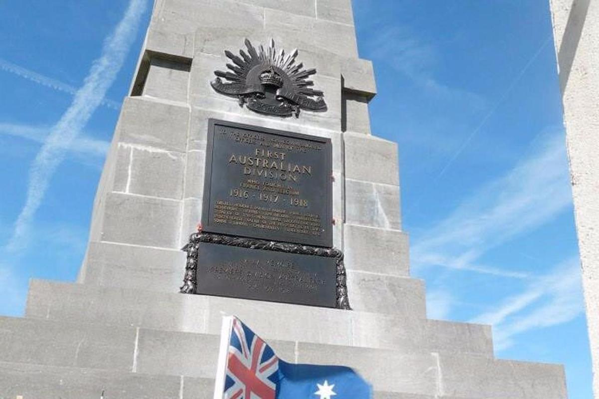 a tower with a sign on it with a flag