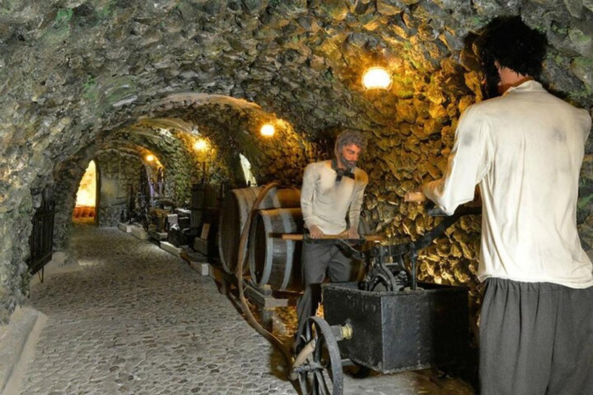 due uomini in piedi in un tunnel di pietra con un uomo in bicicletta