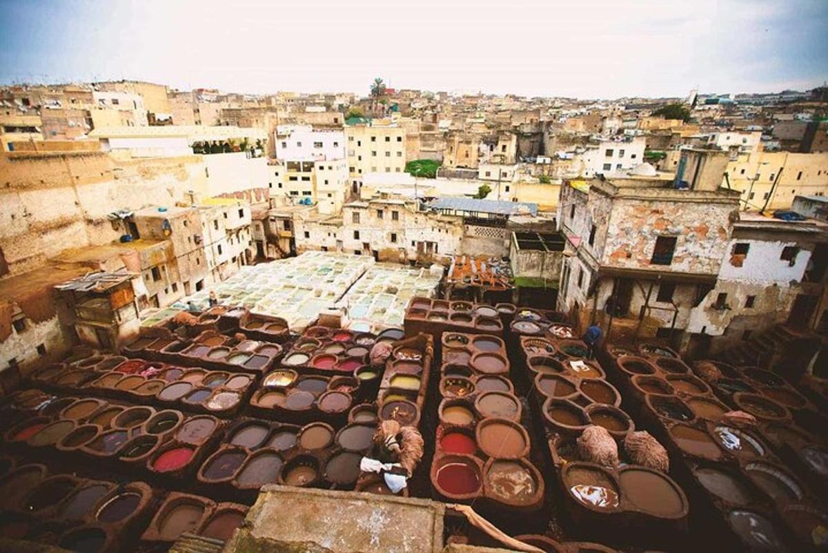an aerial view of a city with a lot of roofs