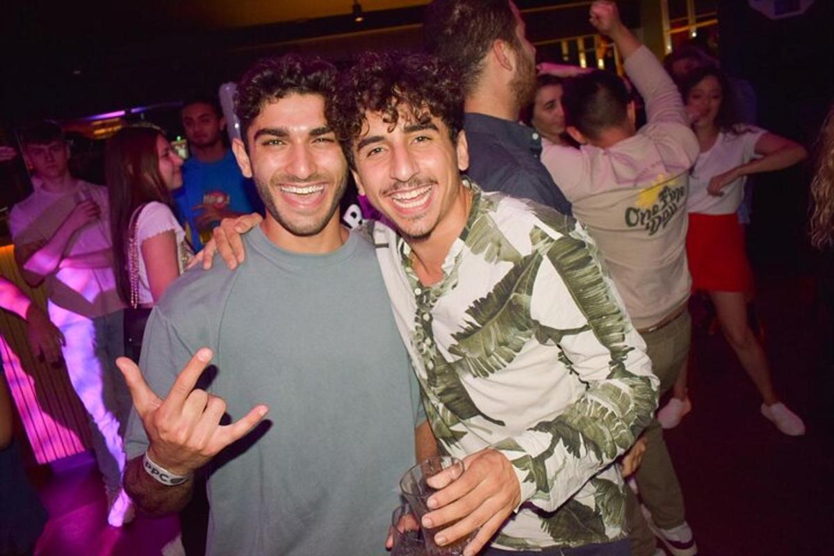 two men posing for a picture at a party