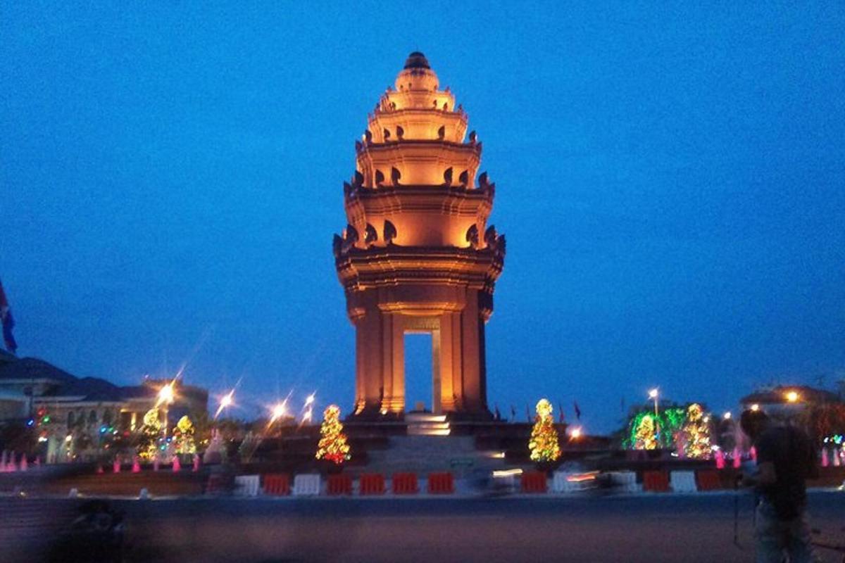 ein großer Glockenturm mit Weihnachtsbäumen davor