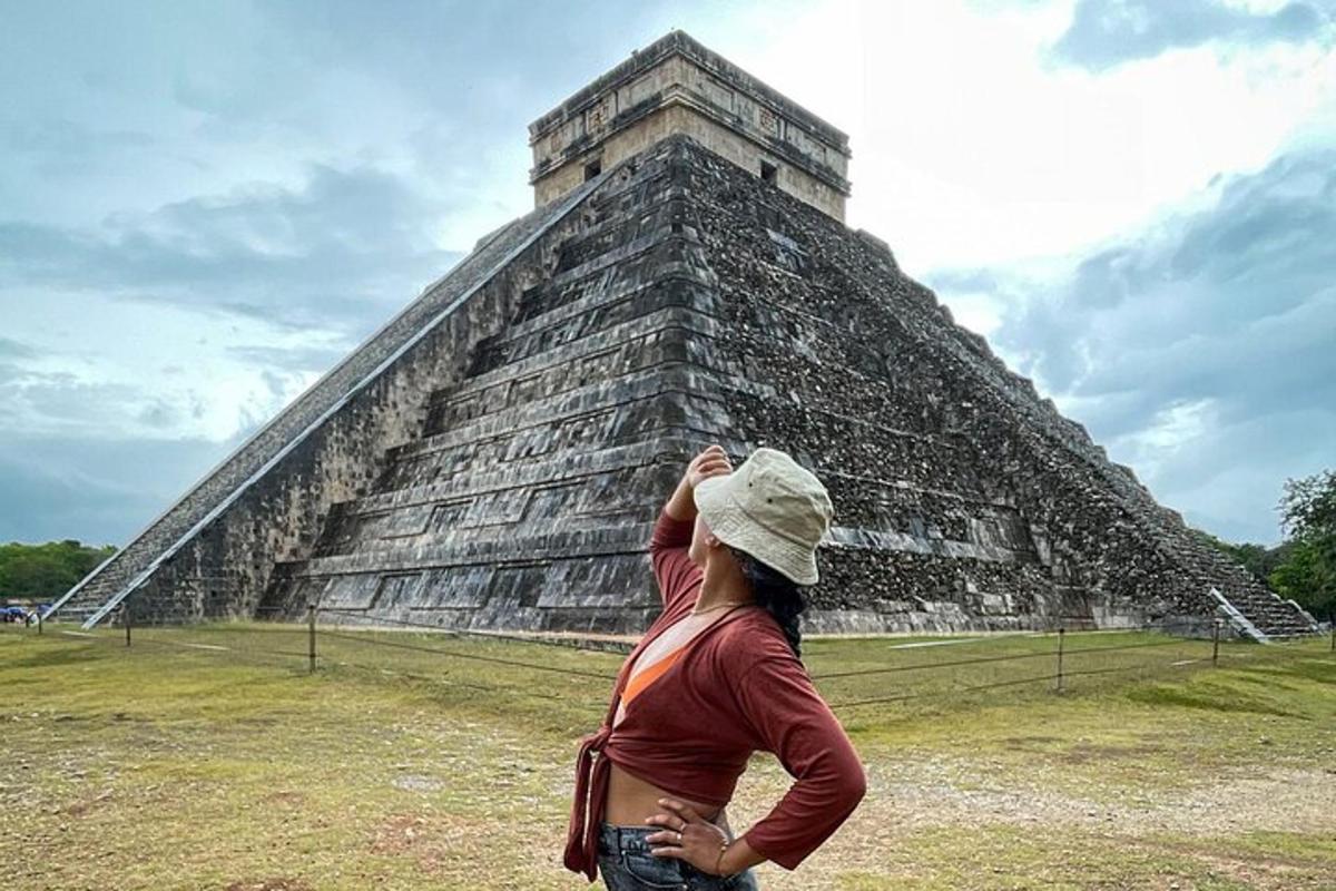 a woman standing in front of a pyramid
