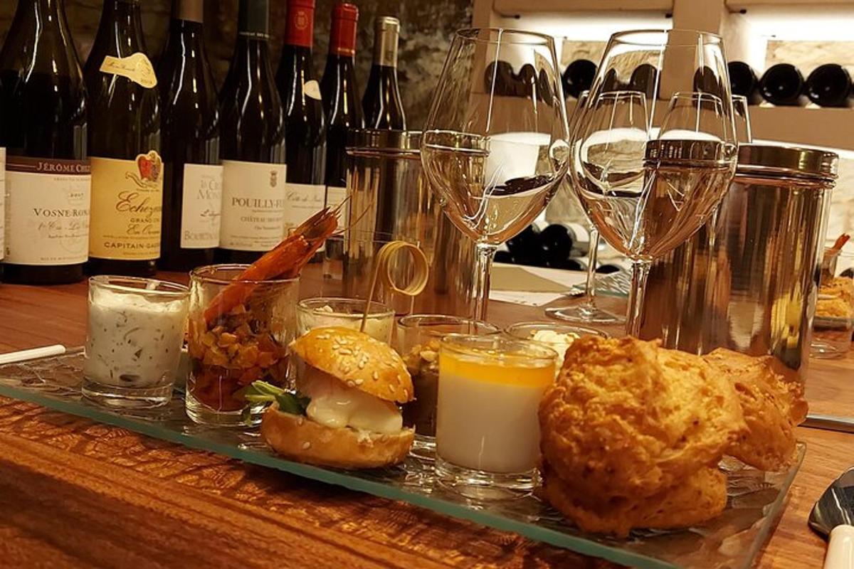 a tray of food on a table with wine glasses