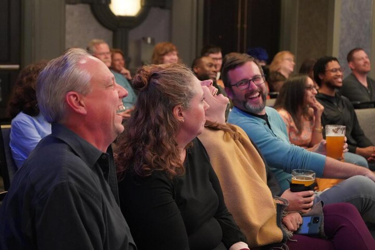 a group of people sitting in a room with beer