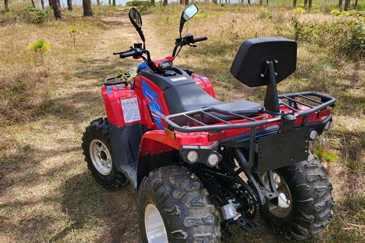 a red four wheeler parked in a field