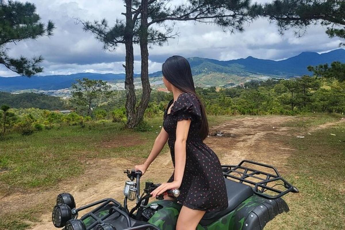 a woman in a dress standing next to a motorcycle
