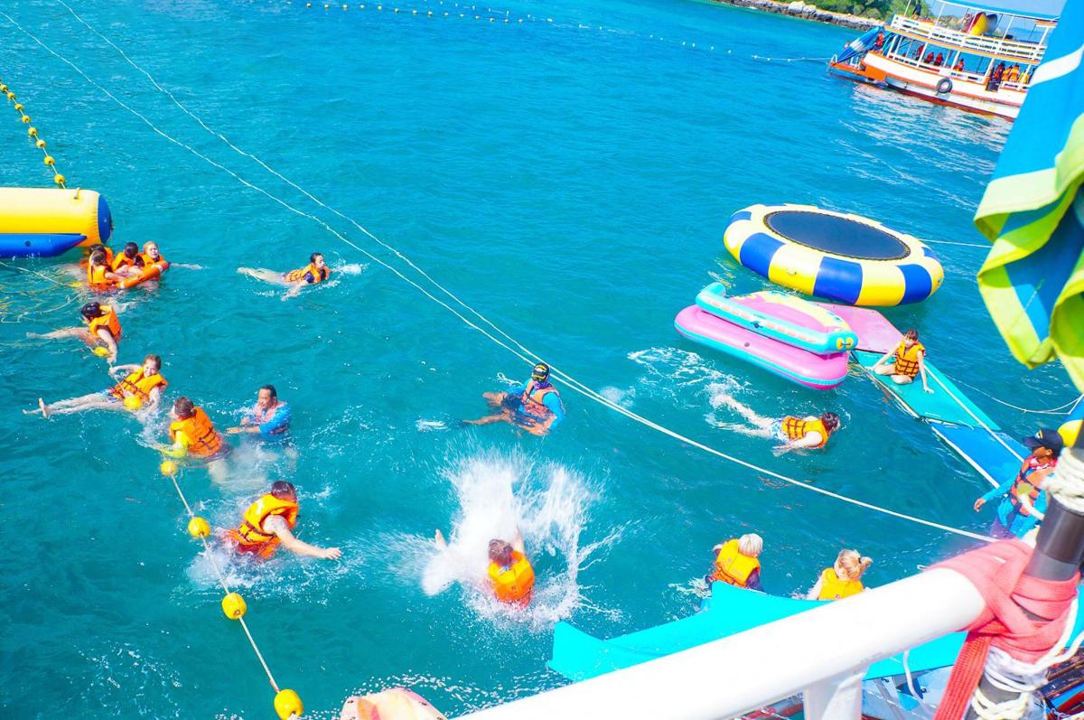 a group of people in the water on a boat