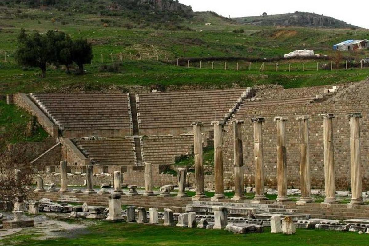 an amphitheater with columns and stands in a field