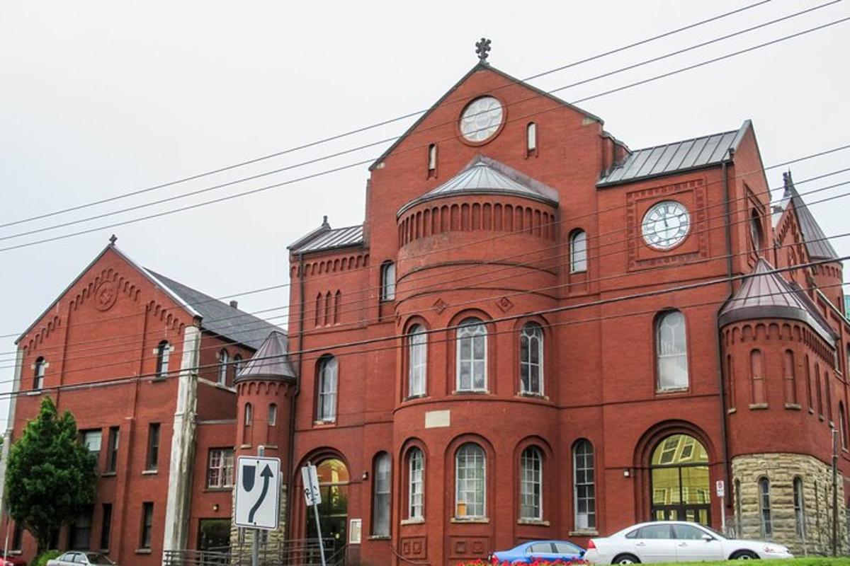 a large red brick building with a clock tower