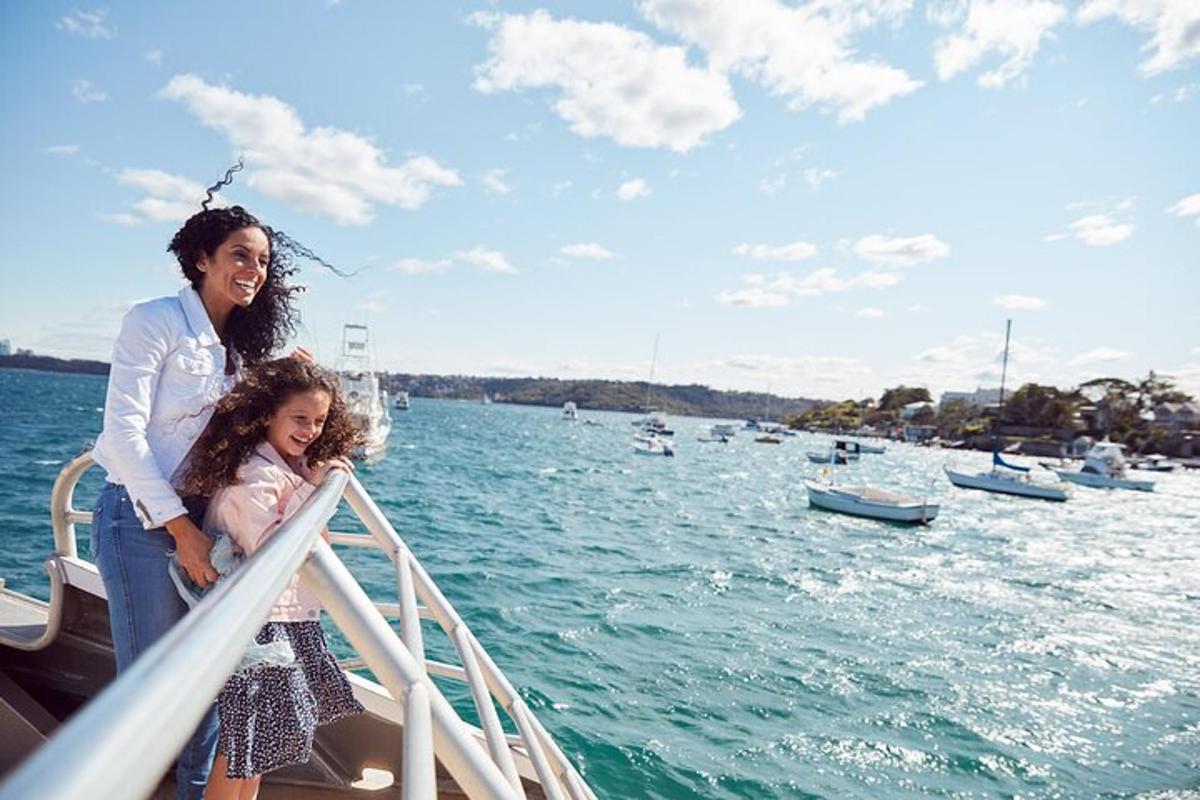 a woman and a little girl standing on a boat