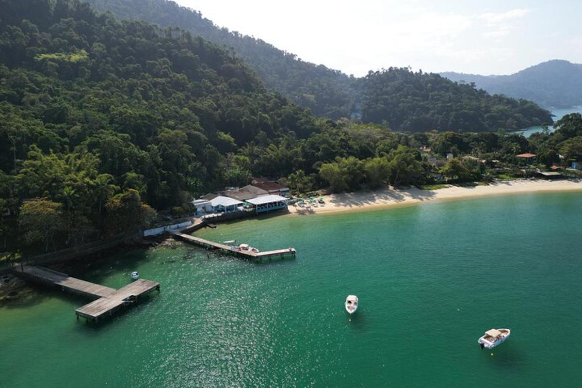 an aerial view of a beach with boats in the water