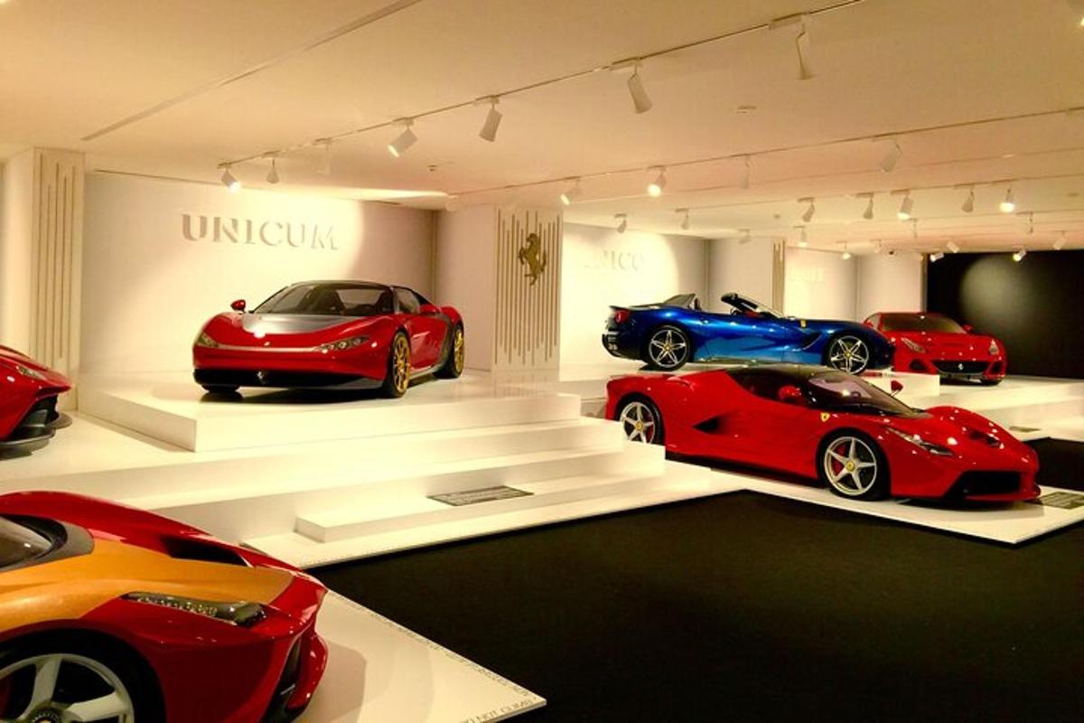 a display room with three cars on display