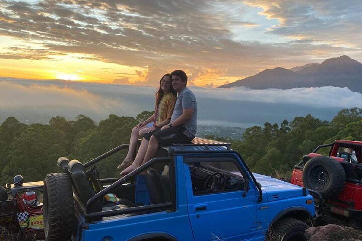 a man and woman sitting on the top of a truck