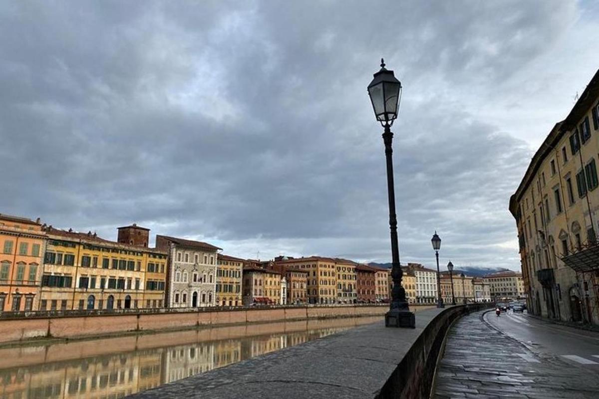 a street light next to a river with buildings