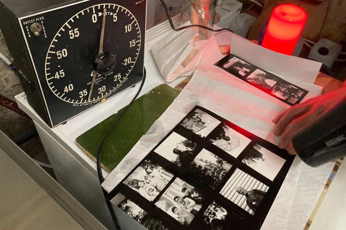 a clock sitting on top of a table with pictures