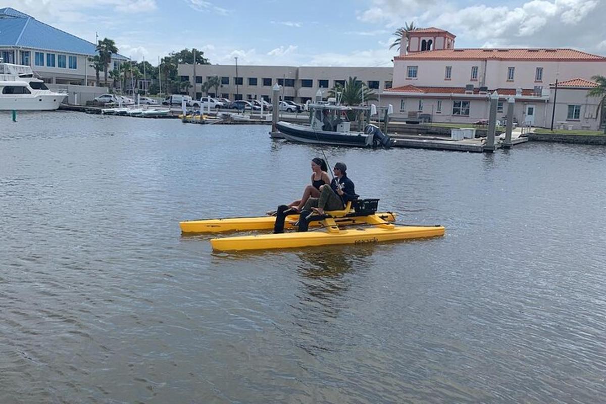 two people sitting on a yellow raft in the water