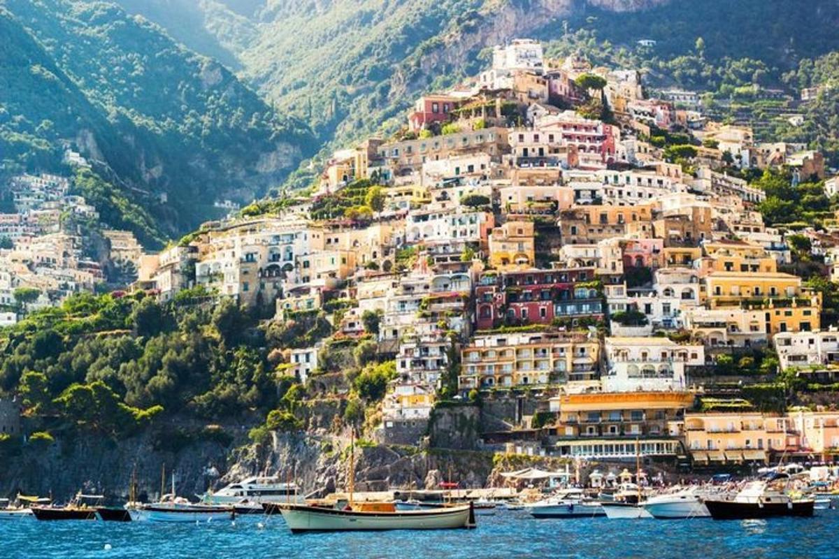 a town on a hill with boats in the water