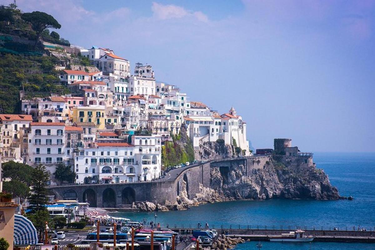 a group of buildings on a hill next to the ocean