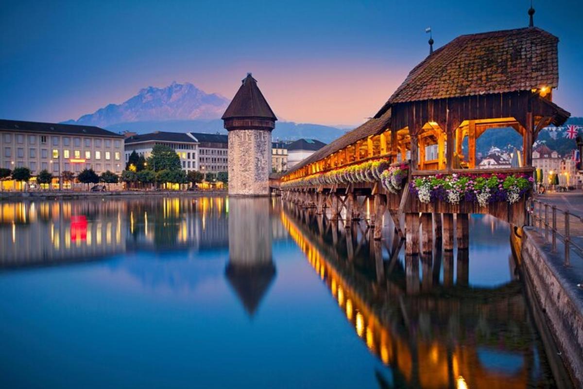 a bridge over a lake with a building and a tower