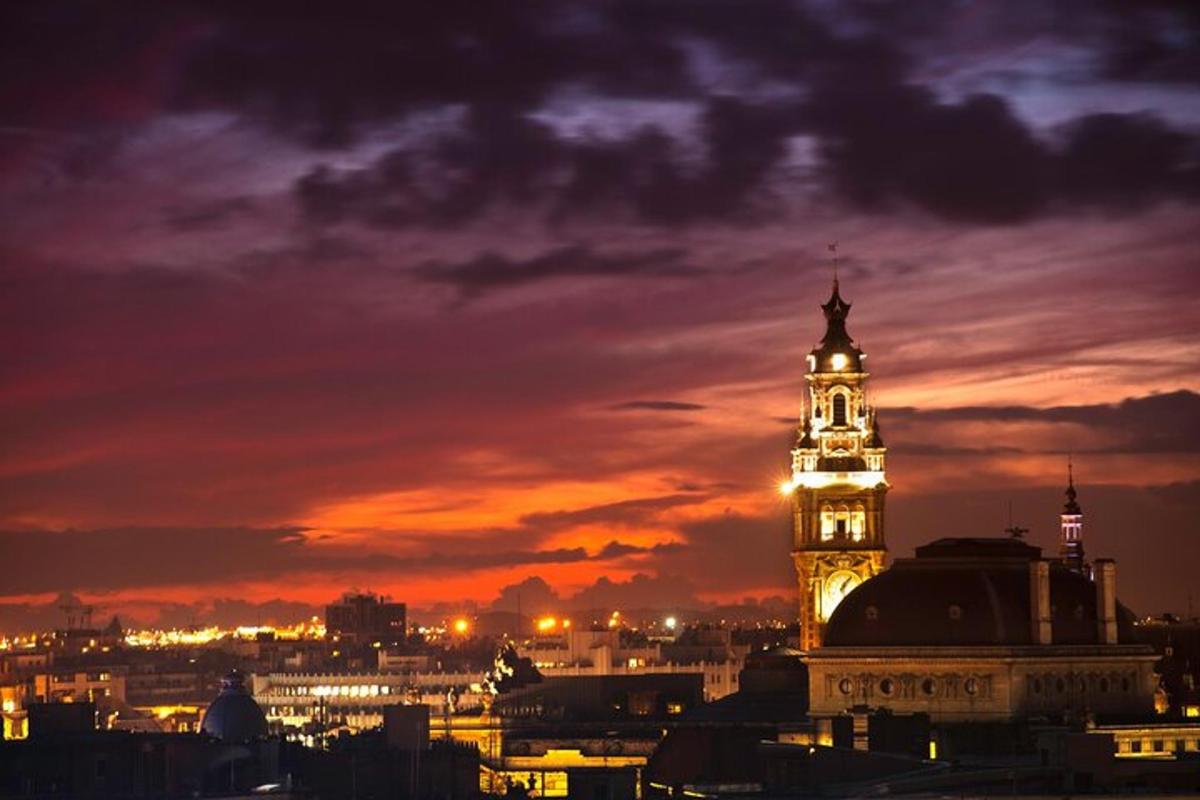 a lit up clock tower in a city at night