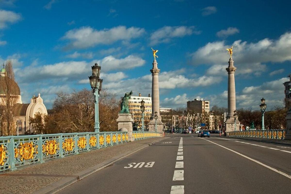 a bridge over a street with columns and a city