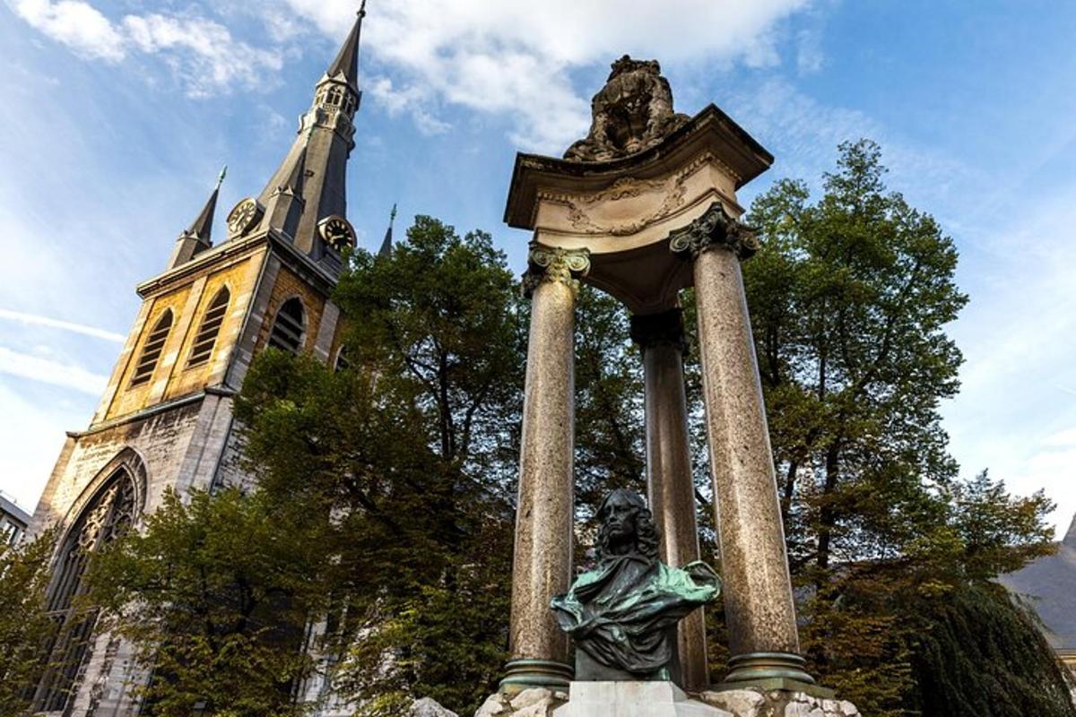a statue in front of a church with a tower