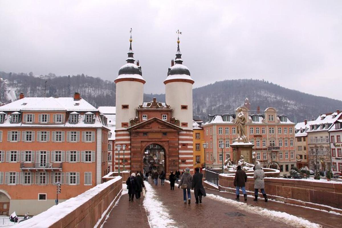 a group of people walking across a bridge with buildings