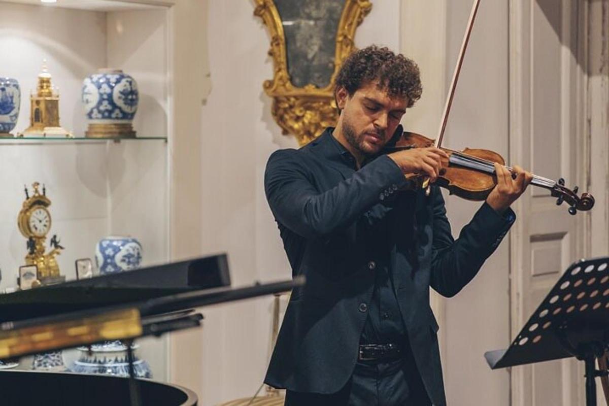 a man playing a violin in a room