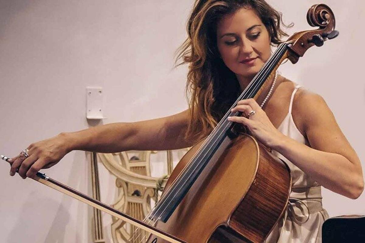 a woman playing a cello with a stick