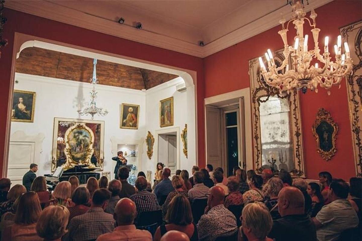 a crowd of people sitting in a room with a man preaching