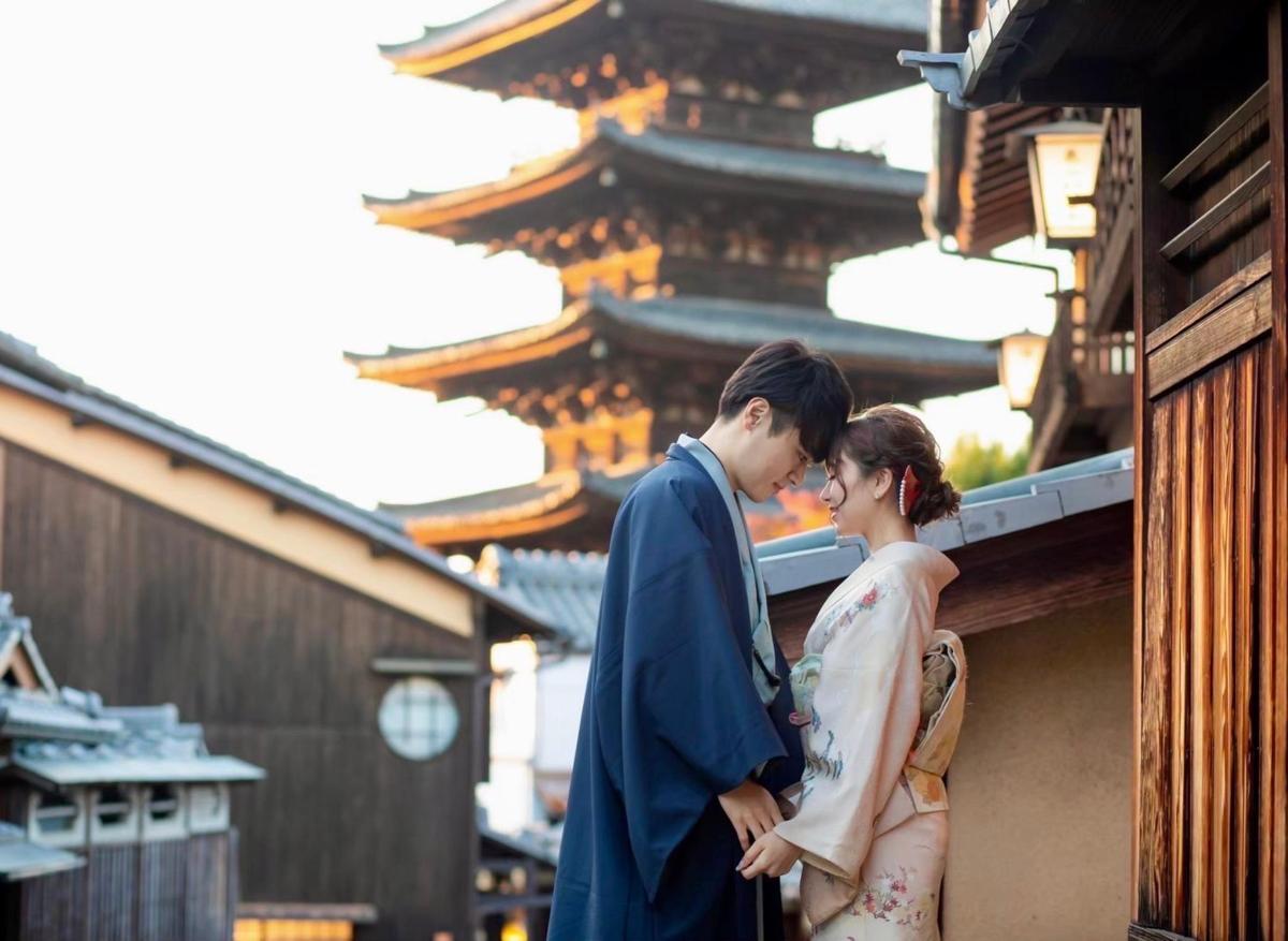a man and a woman standing next to a building