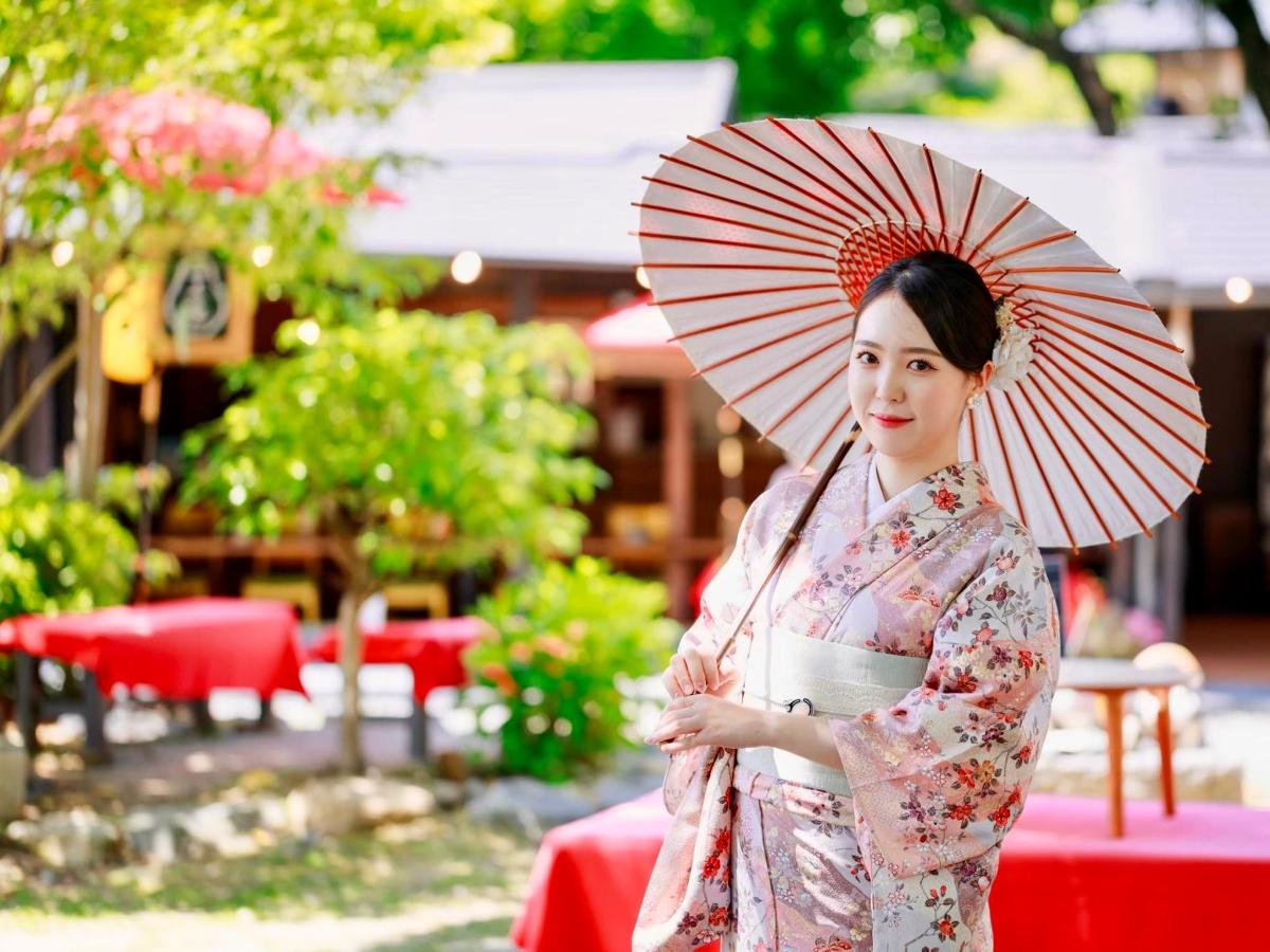 a woman in a kimono holding a parasol