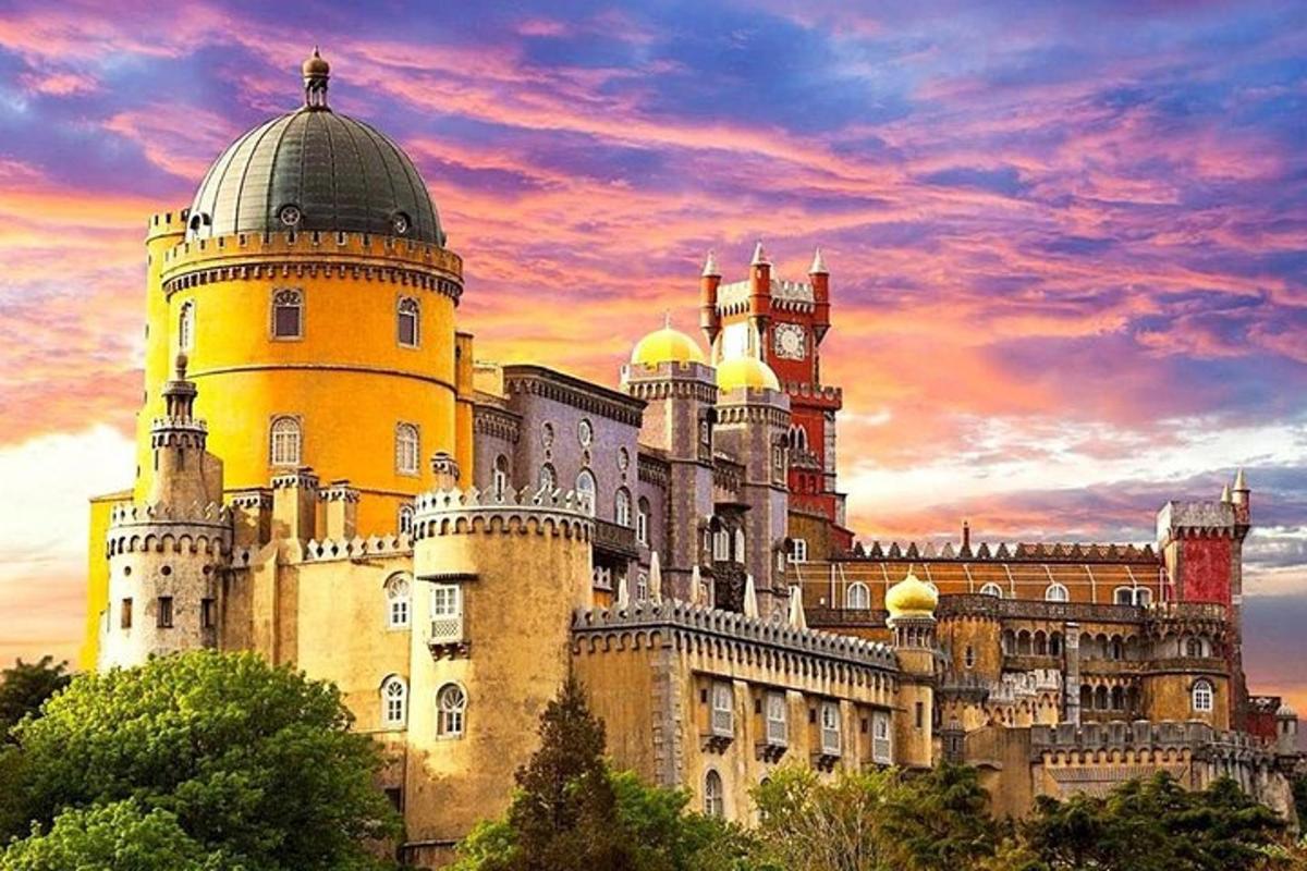 a castle with a sunset in the background