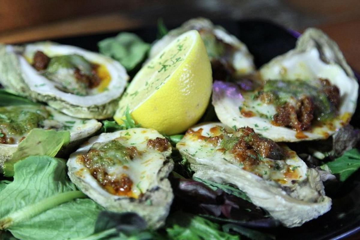 a plate of food with oysters and a lemon