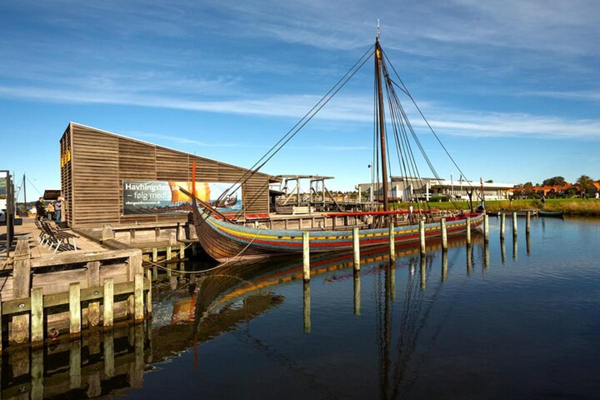 a boat is docked next to a building in the water