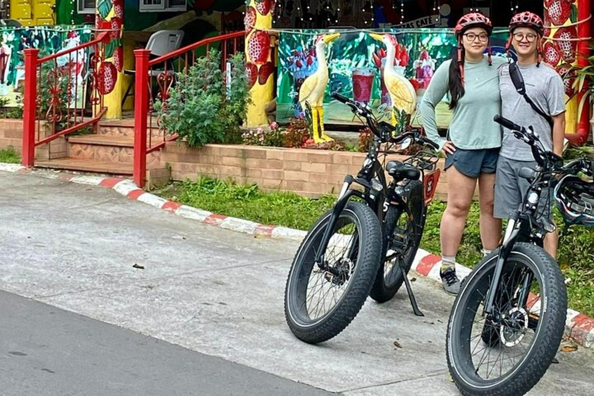 two women are standing next to their bikes