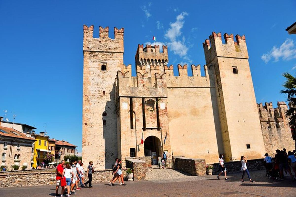 Un grupo de personas de pie afuera de un castillo.