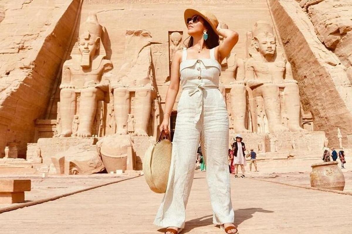 a woman in a white jumpsuit standing in front of thearaoharaoh