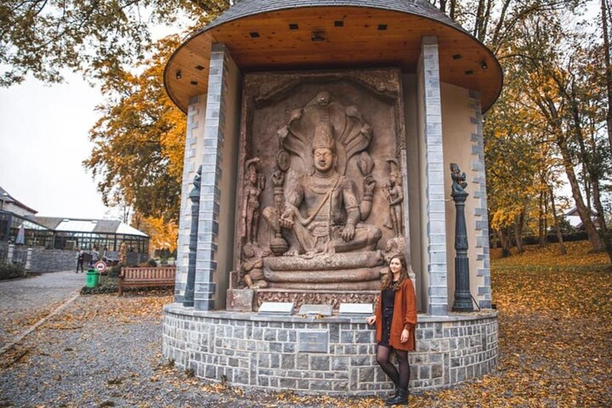 a woman is standing in front of a statue