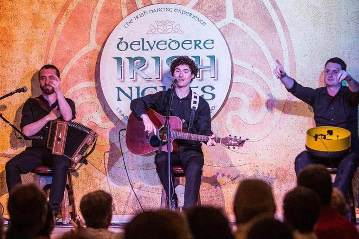 a group of three men on a stage playing music