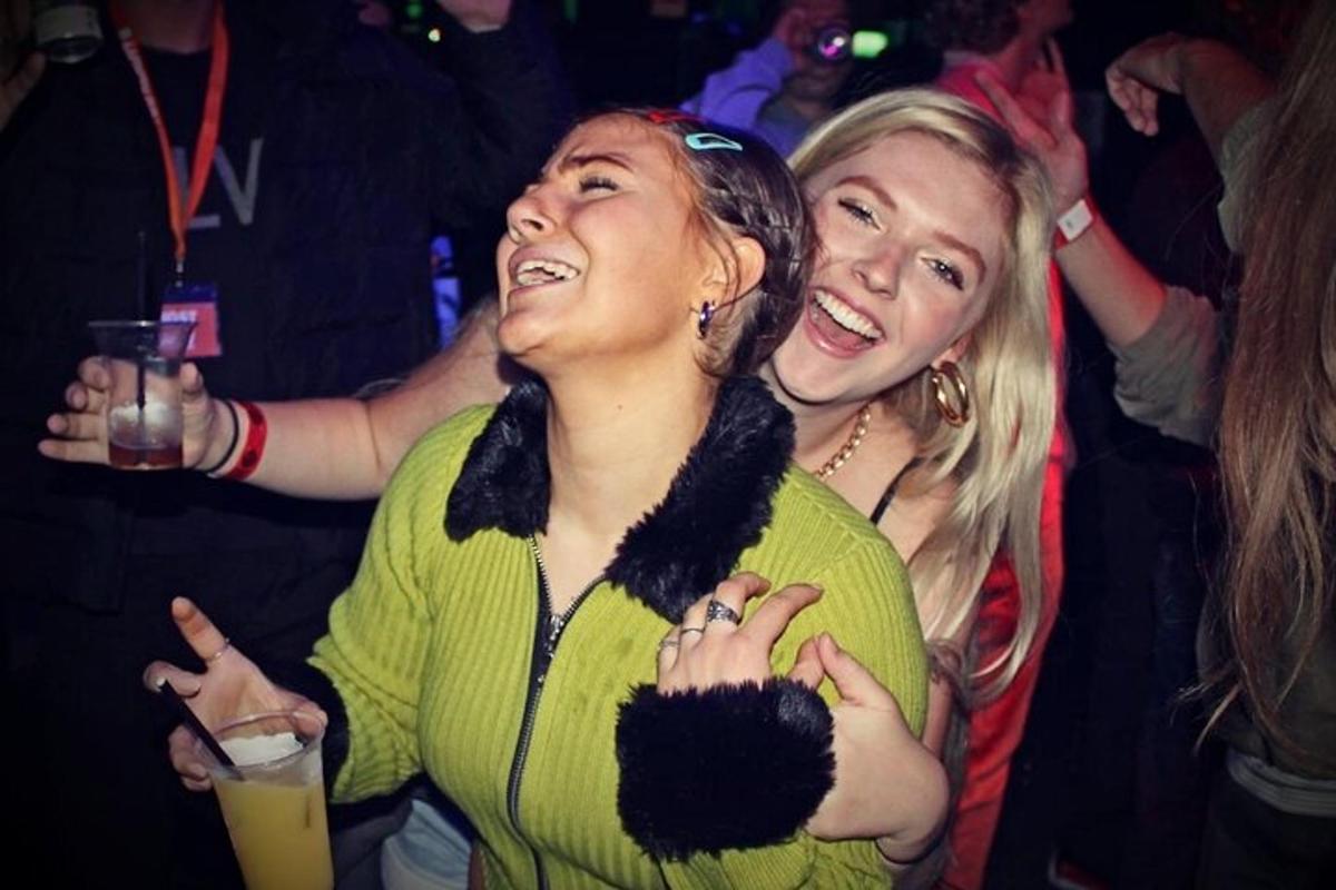 two women standing next to each other at a party