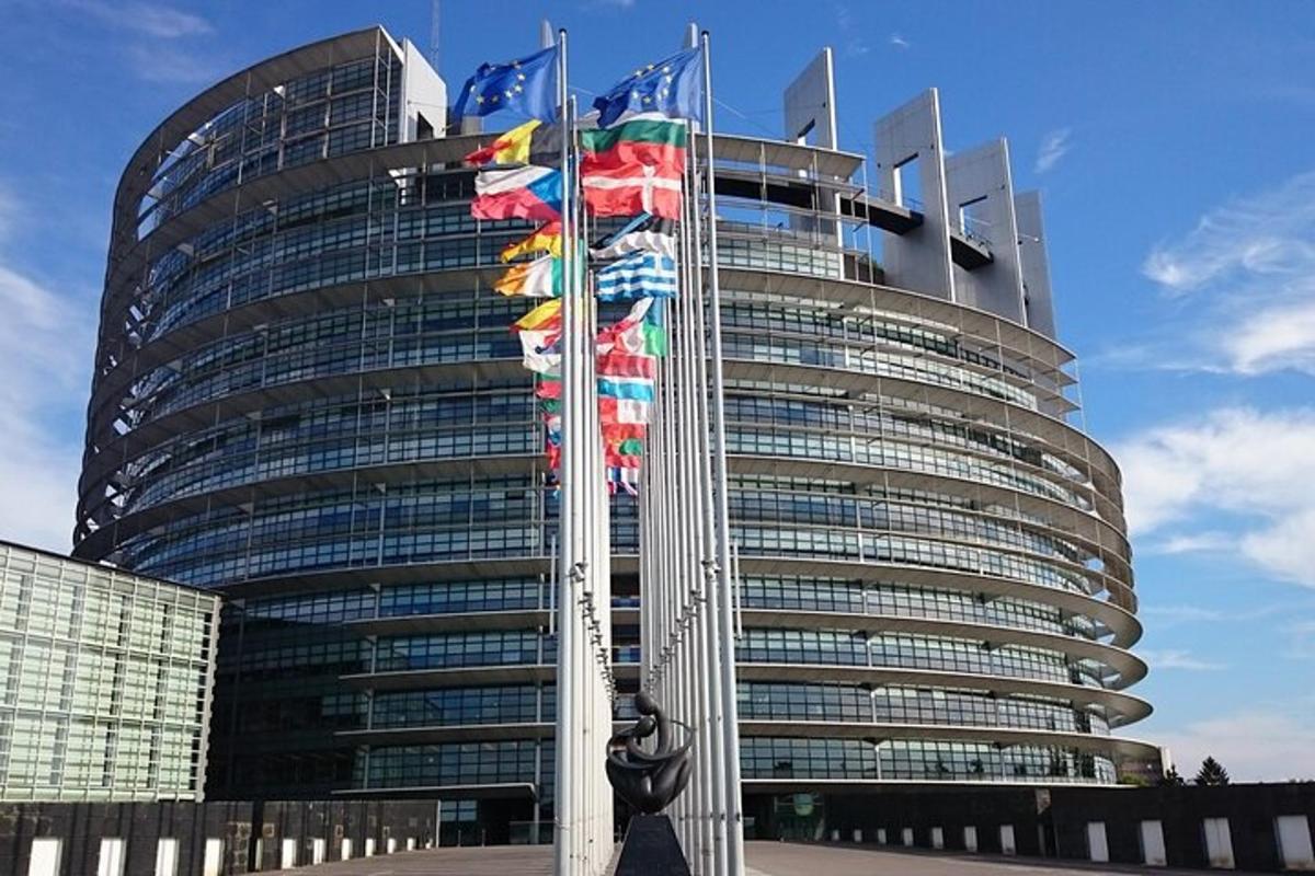 a tall building with flags in front of it