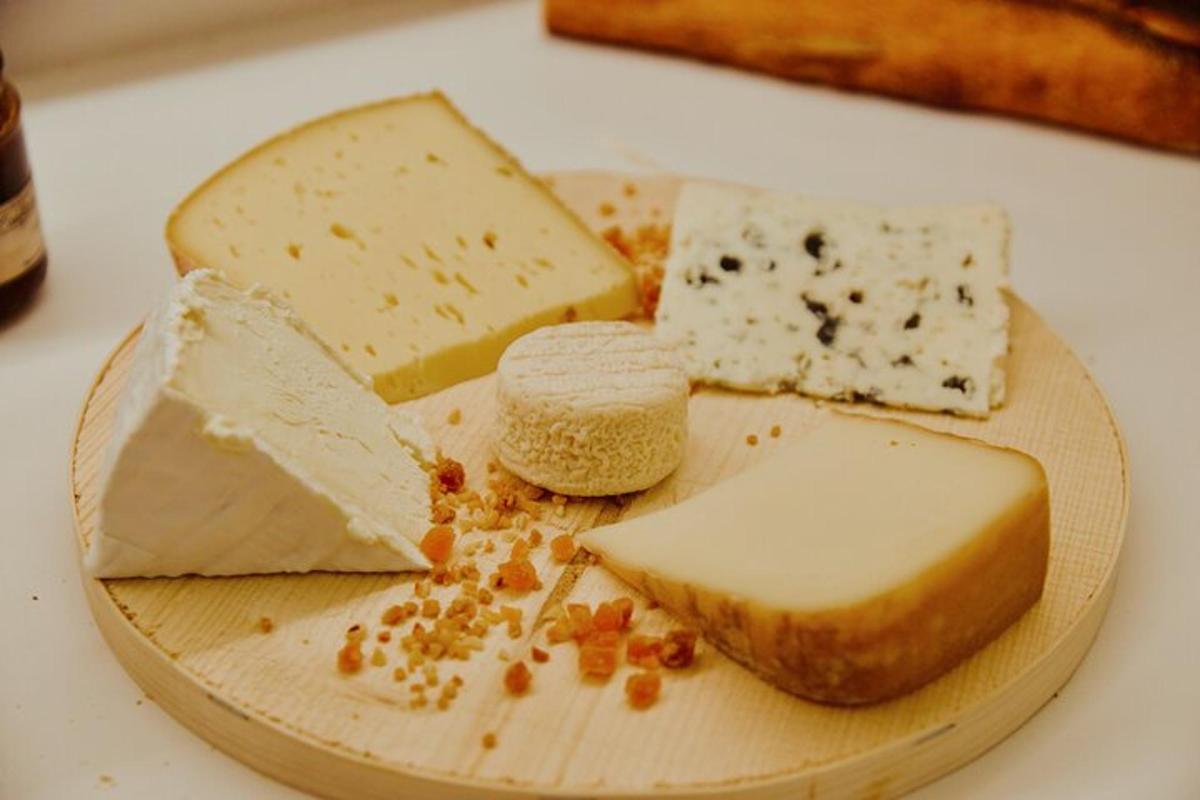 puidust taldrik, millel on erinevat tüüpi juustud