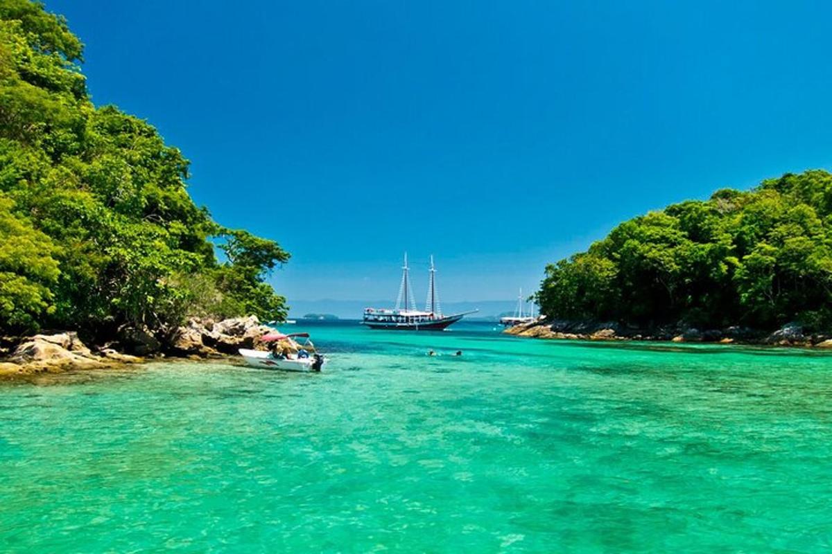 a boat in the water next to a beach