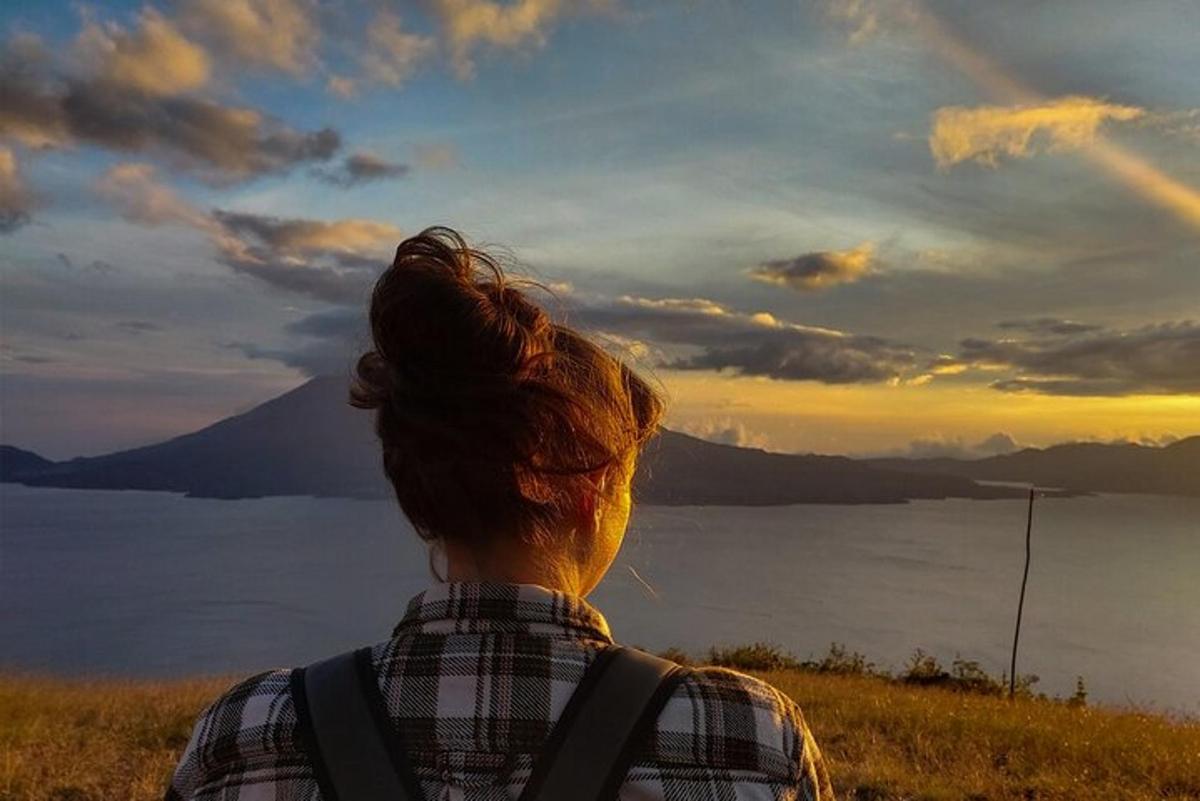 a person with a backpack looking out over a body of water