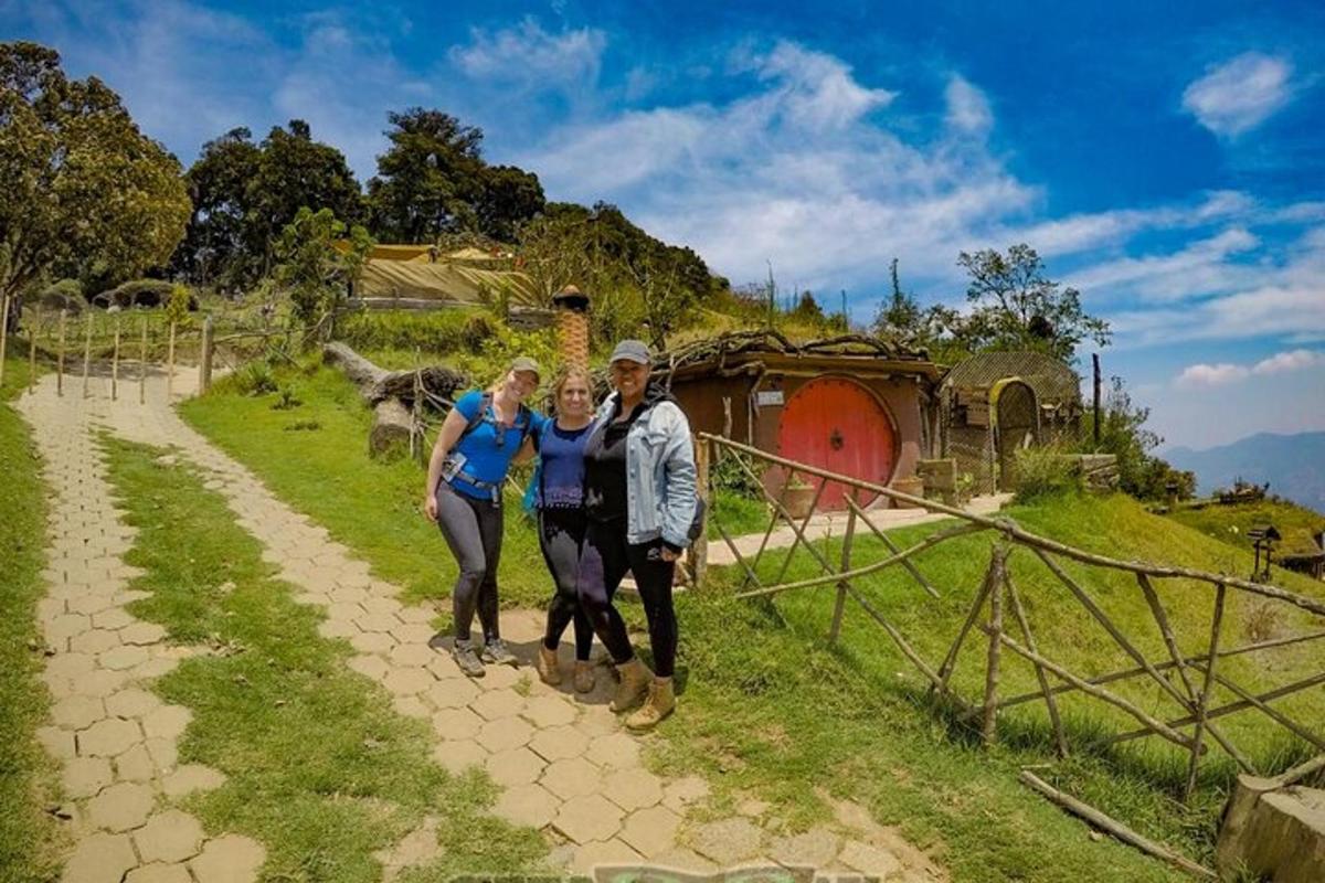 a group of people standing on a dirt road