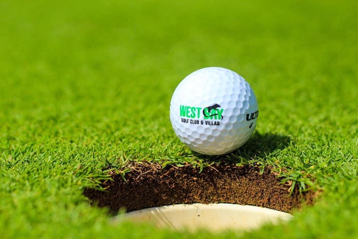 a white golf ball sitting on top of the grass